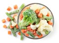 Frozen vegetables in a plate and sprinkled on a white. Top view. Royalty Free Stock Photo