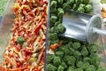 Frozen vegetables in the supermarket. Spinat in briquettes and red pepper. Ready-made semi-finished products and quick food. Close