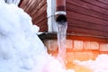 frozen water in downspout gutter of the roof drainage system with ice