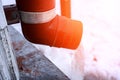 frozen water in downspout gutter of the roof drainage system with ice