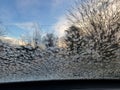 frozen water ice crystals on car window in winter Royalty Free Stock Photo