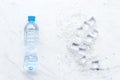 Frozen water in ice cubes and plastic bottle on marble bar table top view mockup Royalty Free Stock Photo