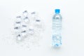 Frozen water in ice cubes and plastic bottle on white bar table top view mockup Royalty Free Stock Photo