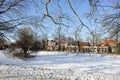 Frozen water and show on canal and traditional old brick buildings with tile roofs at sunny winter day in Hoorn city, Holland