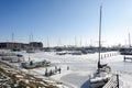 Frozen water and show on sea and boats in harbor at sunny winter day in Hoorn city, Holland Kroon, Netherlands Royalty Free Stock Photo