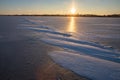 Frozen water surface with subtle ice texture and soft sunlight reflection creating calm abstract winter background Royalty Free Stock Photo