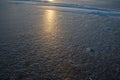 Frozen water surface with subtle ice texture and soft sunlight reflection creating calm abstract winter background Royalty Free Stock Photo