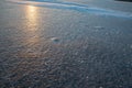 Frozen water surface with subtle ice texture and soft sunlight reflection creating calm abstract winter background Royalty Free Stock Photo