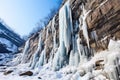 frozen waterfall hanging off a rugged cliff Royalty Free Stock Photo