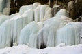 Frozen waterfall with huge beautiful icicles hanging from the rocks Royalty Free Stock Photo