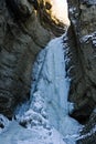 Frozen waterfall with huge beautiful icicles hanging from the rocks Royalty Free Stock Photo