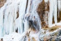 A frozen waterfall with ice in a blue and white color in winter Royalty Free Stock Photo