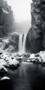 Breathtaking Black And White Waterfall Photo With Snowy Cliff
