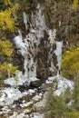 Frozen waterfall through trees Royalty Free Stock Photo