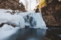 Frozen waterfall under snow cover in Wisla Czarne - Rodla Cascades in the Polish Beskydy Mountains, Poland. Wild nature and its Royalty Free Stock Photo