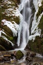 Frozen waterfalls ith rocks and moss and snow Royalty Free Stock Photo