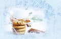 Frozen window and behind it a christmas still life with biscuits Royalty Free Stock Photo