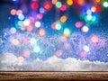 Frozen window with blurred colored lights on a background.