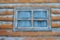 A frozen window in the hunter\'s house. Glass in ice in the forester\'s house in the taiga among the trees. Forest. Royalty Free Stock Photo