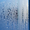 Frozen Window with Intricate Ice Crystal Patterns on Blue Background Royalty Free Stock Photo