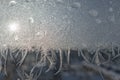 Frozen window in winter time. Frost pattern on the window. Icy flowers on a glass Royalty Free Stock Photo