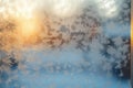 Frozen window in winter time. Frost pattern on the window. Icy flowers on a glass Royalty Free Stock Photo