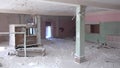 Frozen windows and snow-covered rooms in ruined house in deserted city.