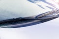 Frozen windshield wiper and glass on car. Frozen windshield. Frozen white car in winter. Ice on front window of a car Royalty Free Stock Photo