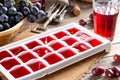 Frozen wine. Wine in ice cube tray on a wooden table