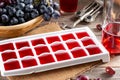 Frozen wine. Wine in ice cube tray on a wooden table