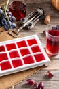 Frozen wine. Wine in ice cube tray on a wooden table