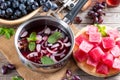 Frozen wine sauce in a stewpan on a wooden table