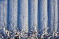 Frozen winter background, Striped surface and fallen leaves densely covered with thick frost