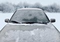 Frozen winter car covered snow, view front window windshield and hood on snowy forest Royalty Free Stock Photo