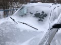 Frozen winter car covered snow, view front window windshield on snowy background Royalty Free Stock Photo