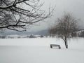 Frozen winter landscape with snow covered bench Royalty Free Stock Photo