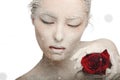 Frozen woman in snow and with rose his hands