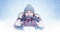 A frozen woman in winter clothes is driving a car, steering wheel in hand, snow is falling on a blue background, front view. Royalty Free Stock Photo