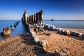 Frozen wooden breakwaters line at Baltic Sea