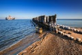 Frozen wooden breakwaters line at Baltic Sea