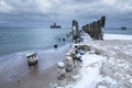 Frozen wooden breakwaters line to the world war II torpedo platform at Baltic Sea Royalty Free Stock Photo