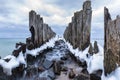 Frozen wooden breakwaters line to the world war II torpedo platform at Baltic Sea Royalty Free Stock Photo