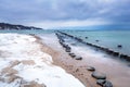 Frozen wooden breakwaters line to the world war II torpedo platform at Baltic Sea Royalty Free Stock Photo