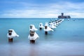 Frozen wooden breakwaters line to the world war II torpedo platform at Baltic Sea Royalty Free Stock Photo