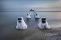 Frozen wooden breakwaters line to the world war II torpedo platform at Baltic Sea Royalty Free Stock Photo