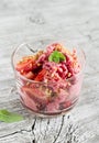 Frozen yogurt with strawberries, biscuits and mint leaves in a glass beaker Royalty Free Stock Photo