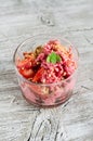 Frozen yogurt with strawberries and cookie crumbs in a glass bowl Royalty Free Stock Photo