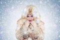 Frozen young woman in a fox fur coat, cold, snow, frost, blizzard Royalty Free Stock Photo