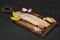 Frozen zander fillet on wooden cutting board Royalty Free Stock Photo