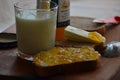 Glass of fresh milk , butter and apricot jam.